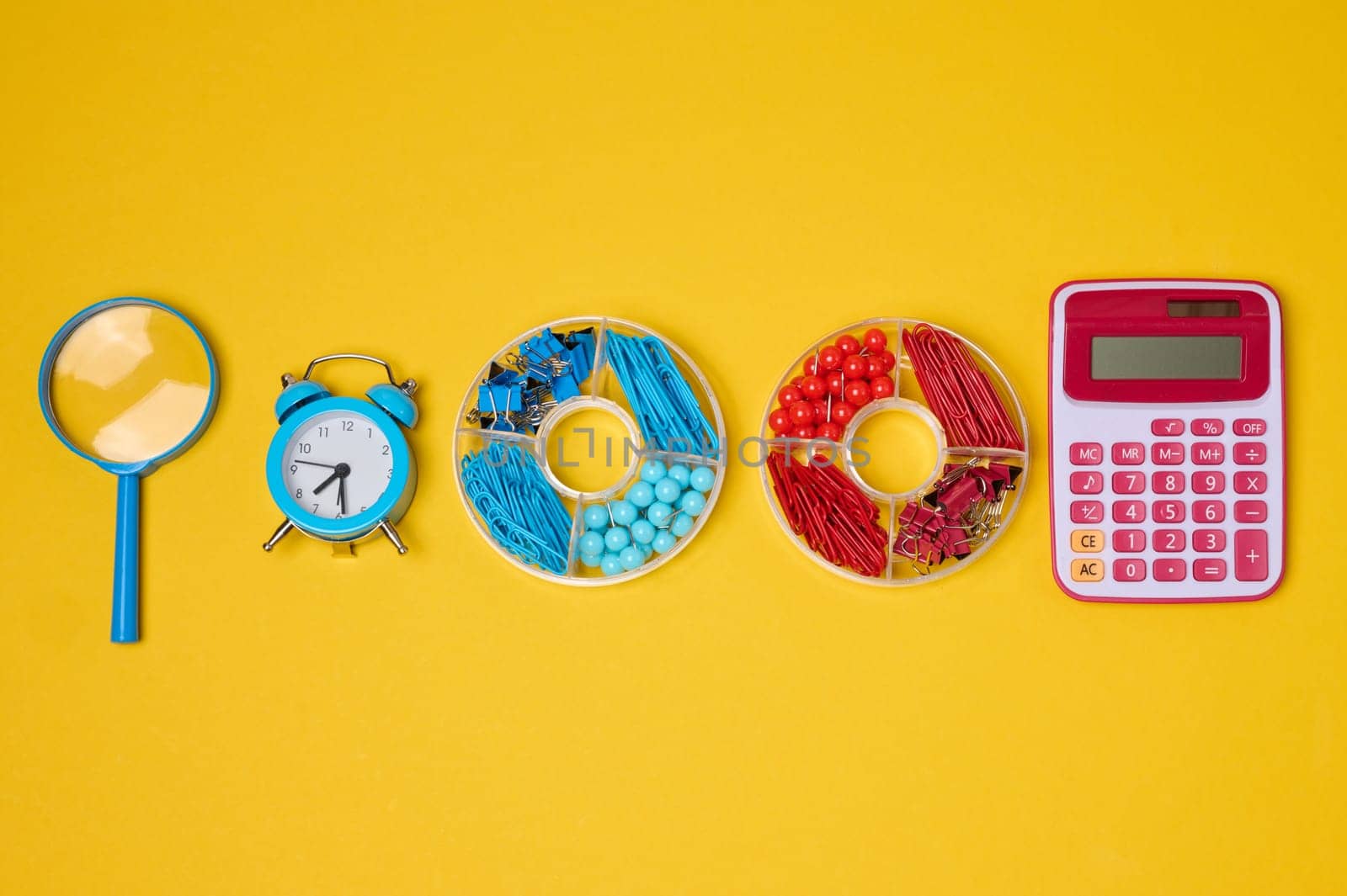 Vibrant collection of colorful school supplies and learning items on a yellow background. Play and education concept.