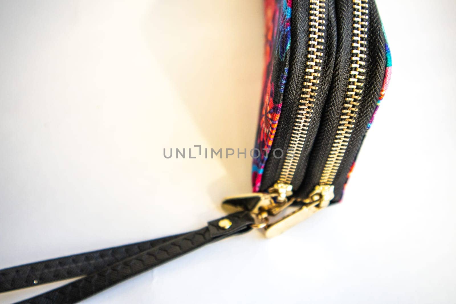 Closed women's textile purse on white background. Selective focus.