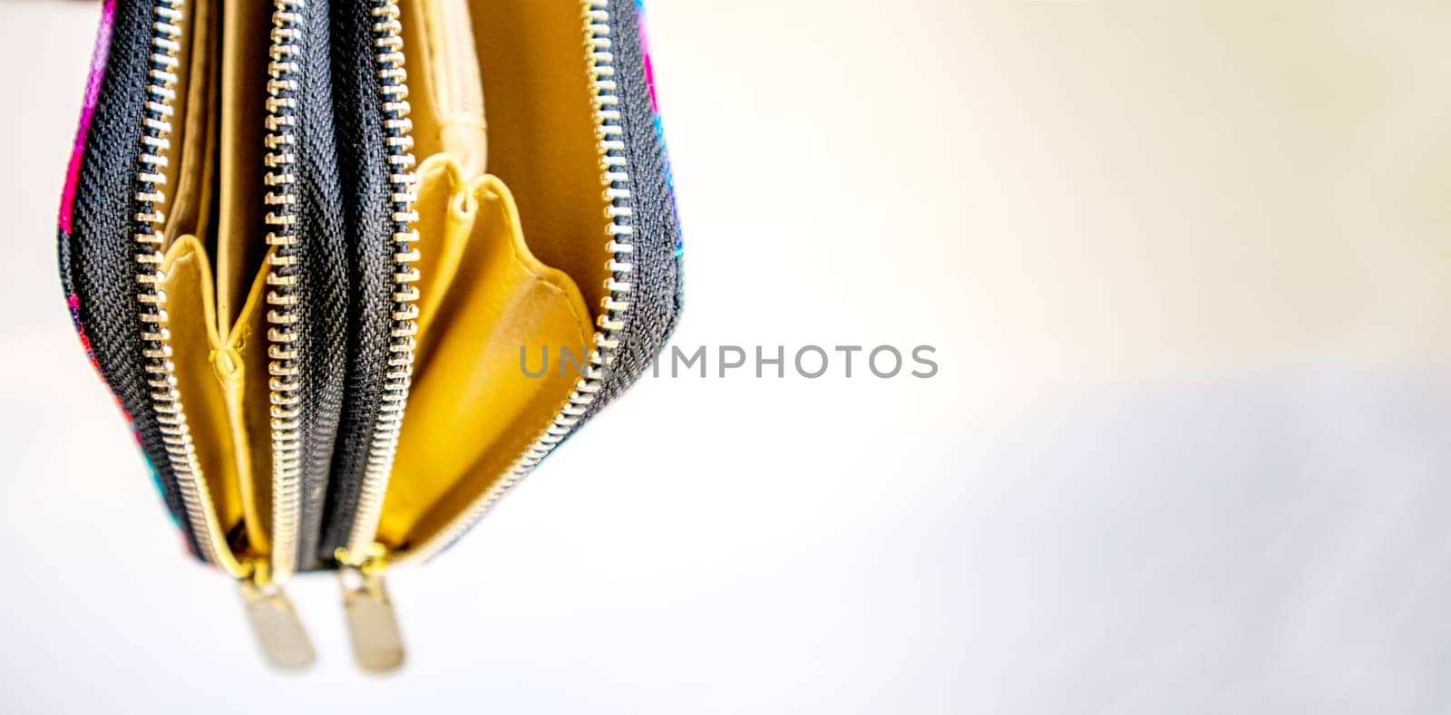 Fashionable outdoor women's empty purse, on a white background, copy space to the right.