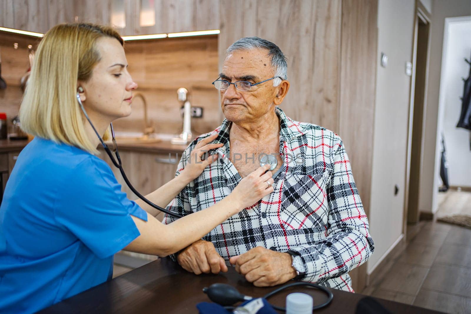 Nurse provides attentive care during a health assessment.