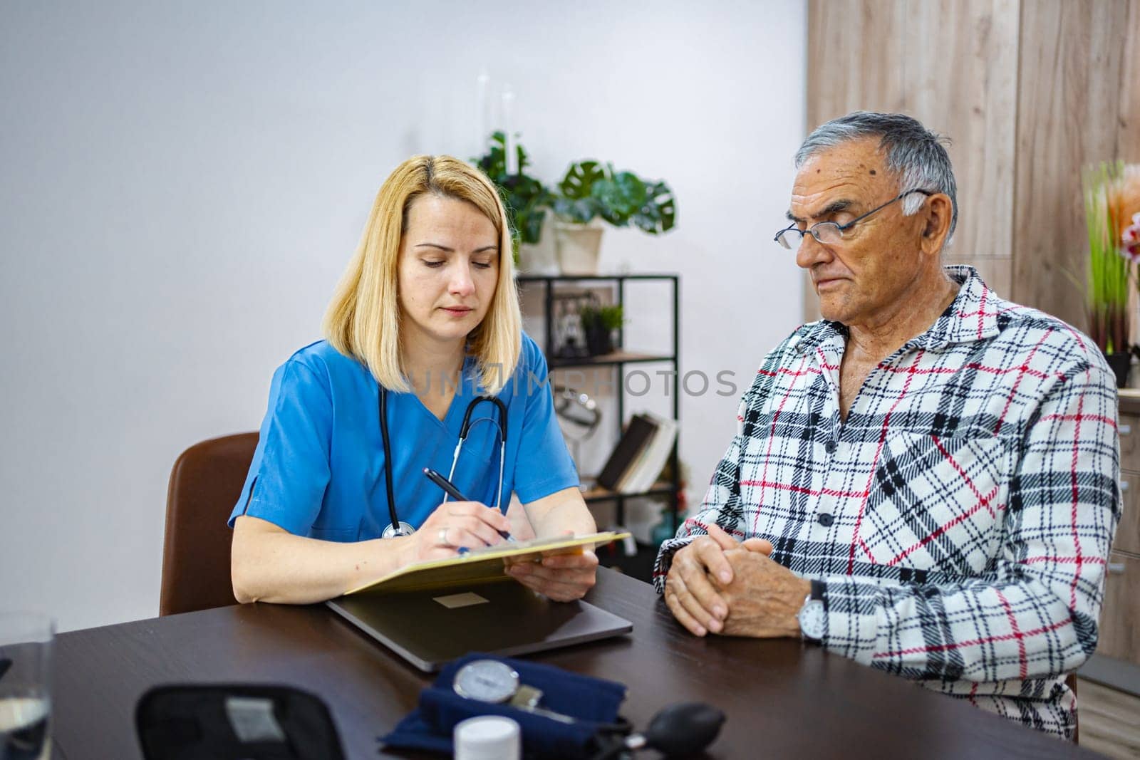 Doctor reviews patient's medical history during appointment.