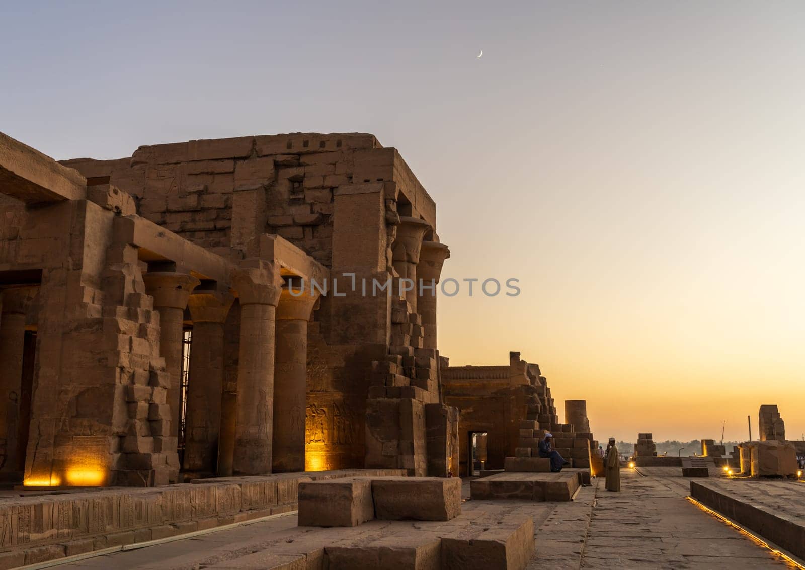 Magnificent temple of Sobek and Horus at Kom Ombo as the sun sets over the river Nile