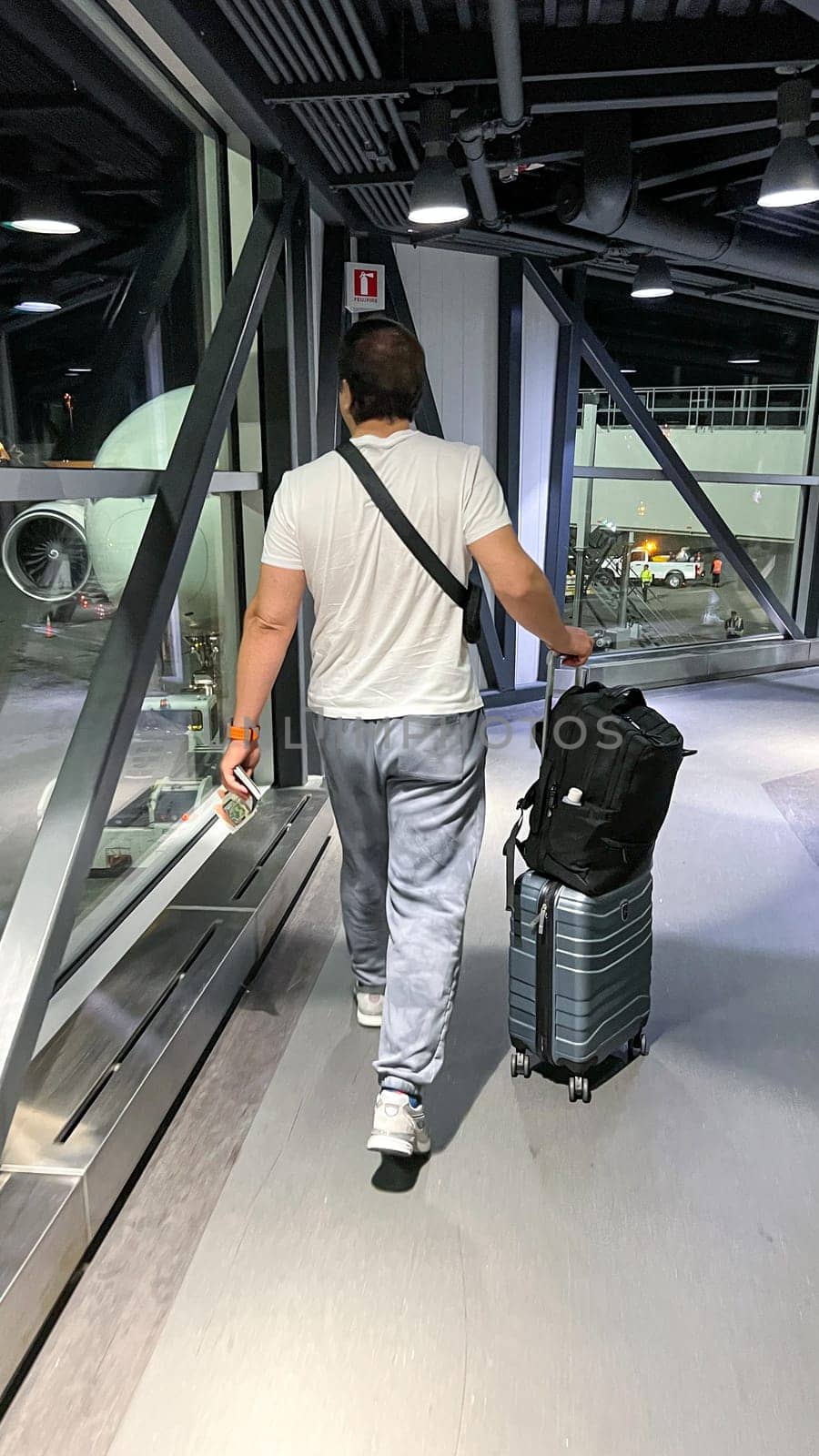 Ottawa, ON Canada - 10.01.2024: Traveler Walking Through Airport Terminal with Luggage, Ready for Adventure and Exploration.