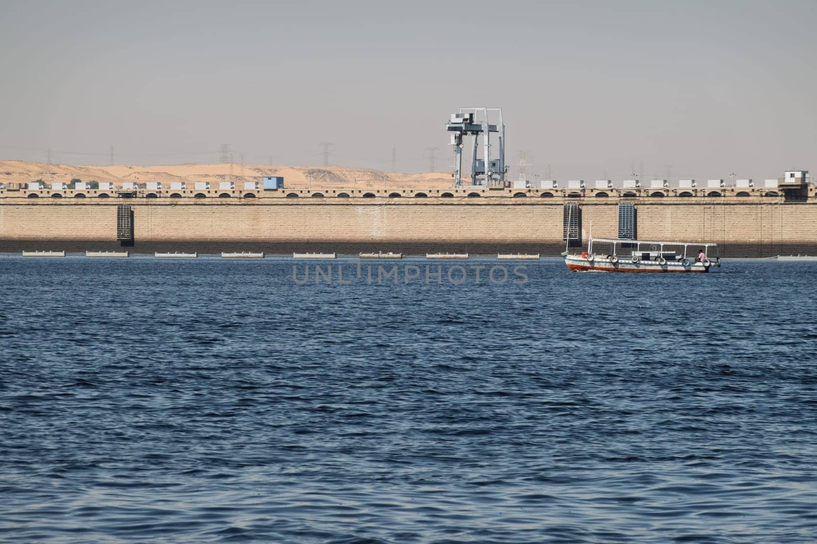 Single tour boats and ferries by the Old Aswan dam used to transport tourists to Philae Temple
