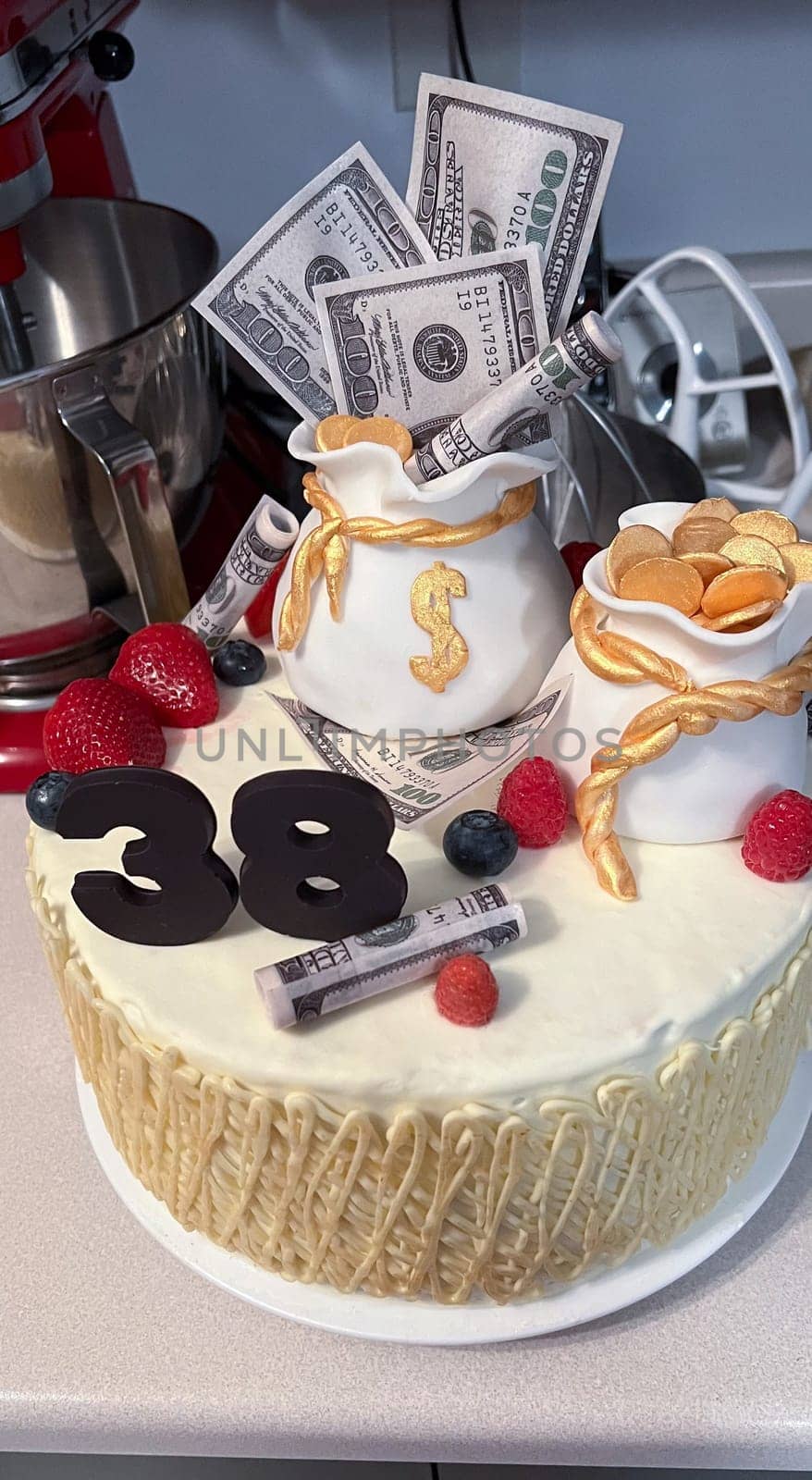 A vibrant cake adorned with money bags and edible currency, celebrating a 38th birthday. Ideal for themes of financial success and special occasions, offering a delightful treat.