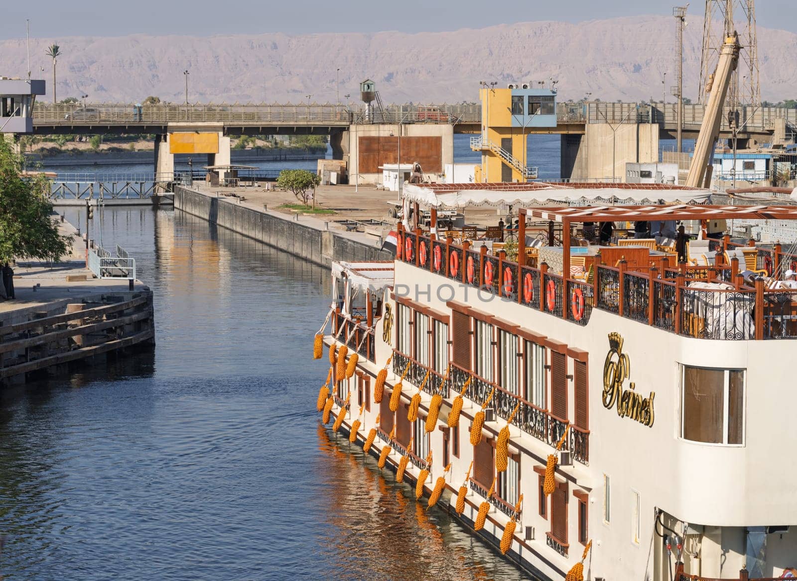 Esna, Egypt - 6 November 2024: Modern Nile river cruise boat entering the new Esna dam and lock on Nile River