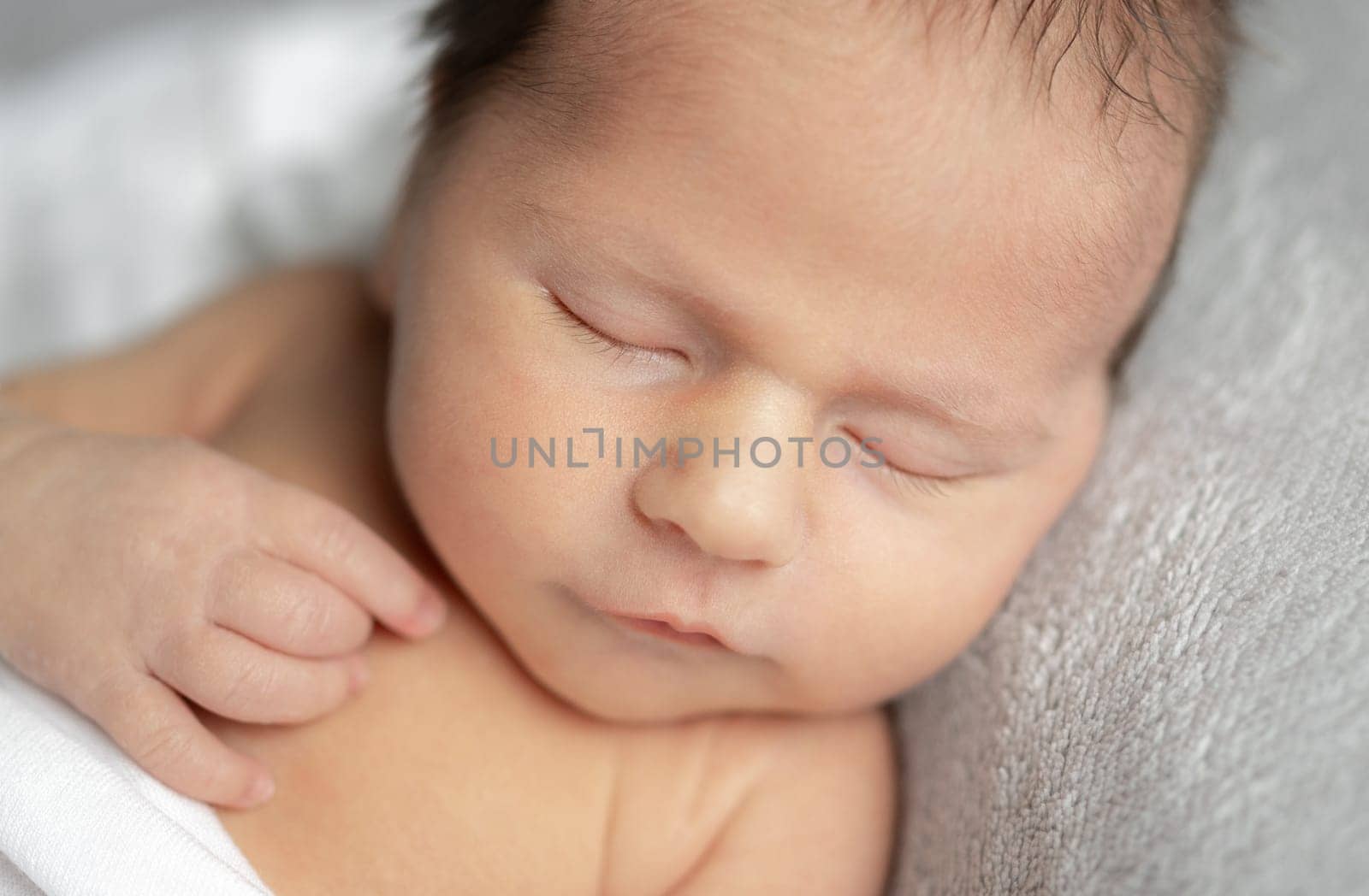 Newborn Baby Sleeping With A Smile In A Studio Photo