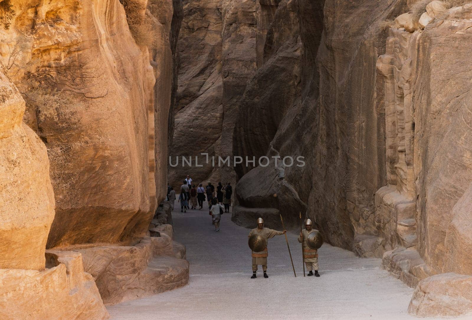 Petra, Jordan - 10 November 2024: Re-enactment soldiers stand guard at the narrow gorge of the Siq entering Petra in Jordan