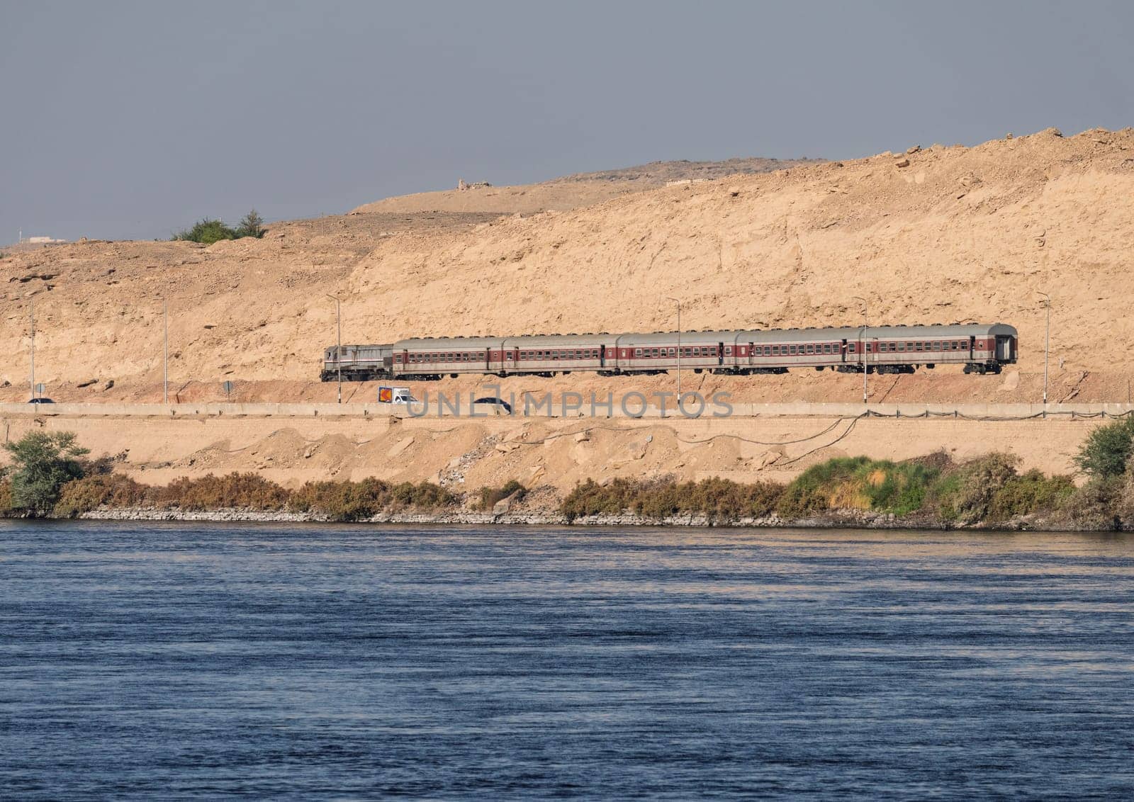 Egyptian passenger train alongside the River Nile near Aswan and heading north