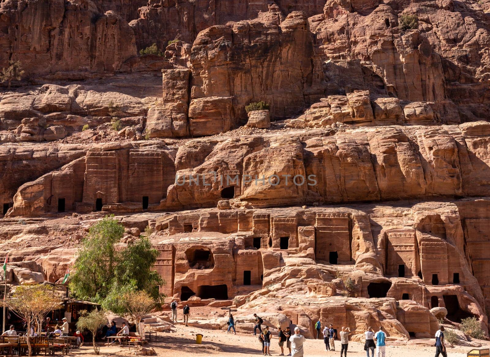 Petra, Jordan - 10 November 2024: Theater Necropolis in the Street of Facades in Petra with double Pylon tombs carved in the hillside