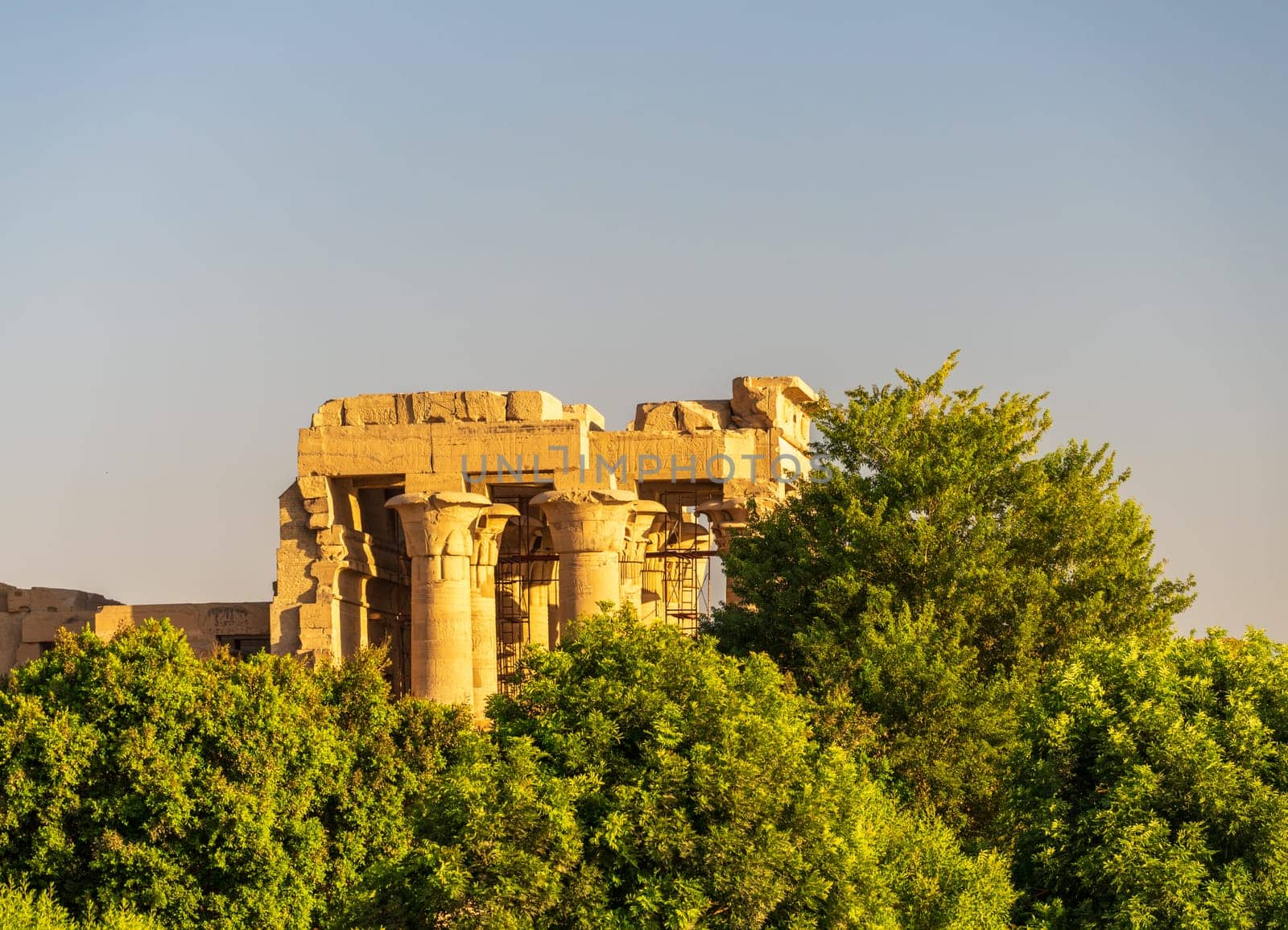 Magnificent temple of Sobek and Horus stands above the trees lining the River Nile at Kom Ombo