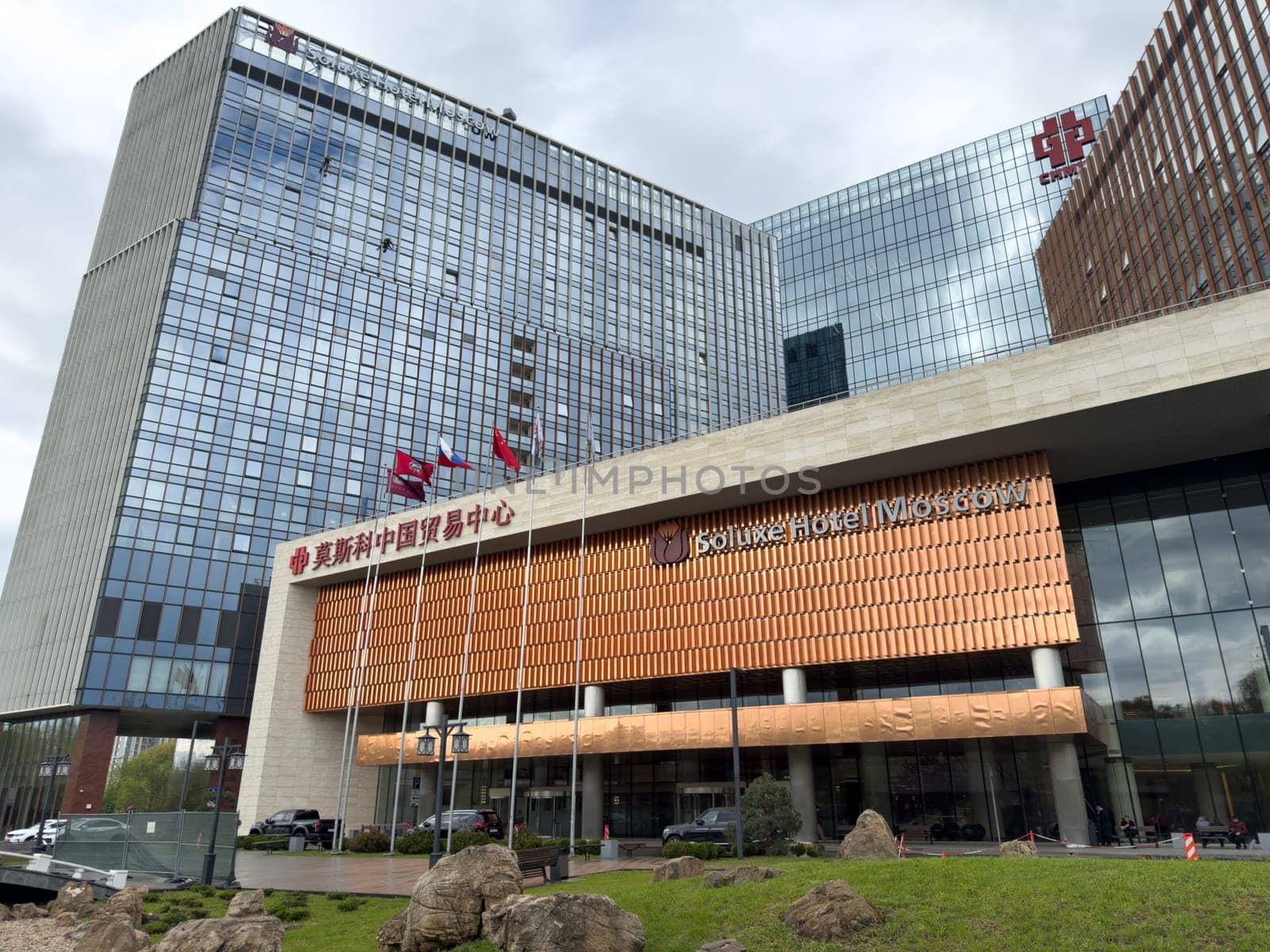 Moscow, Russia, April 25, 2025: Modern glass towers of Park Huamin Business Center rise above surrounding greenery, symbolizing Sino Russian cooperation and urban development