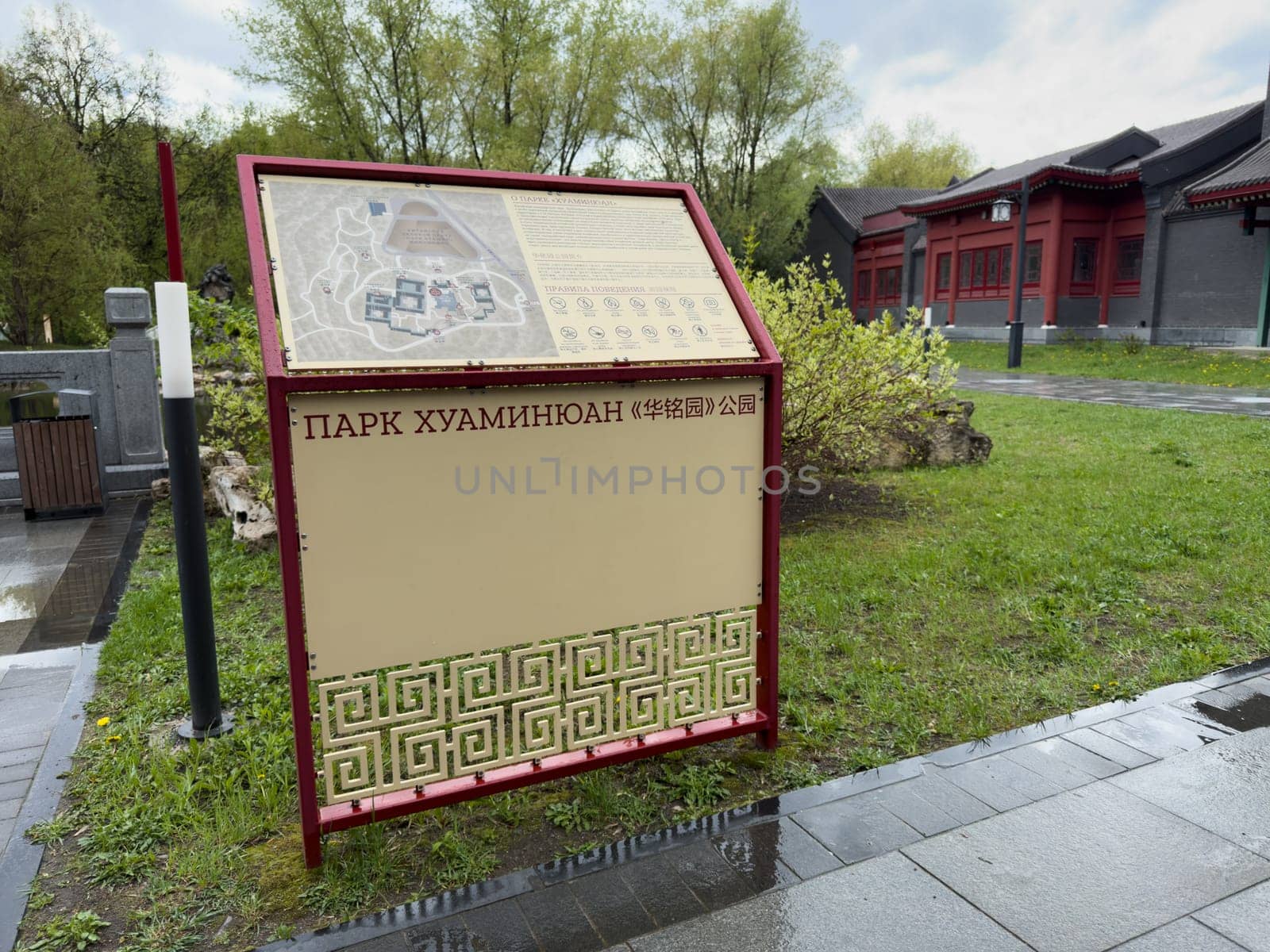 Moscow, Russia, April 25, 2025: Navigation board with detailed map and rules at entrance to Huamin park in Moscow, showcasing bilingual signage and elements of Chinese style in public space