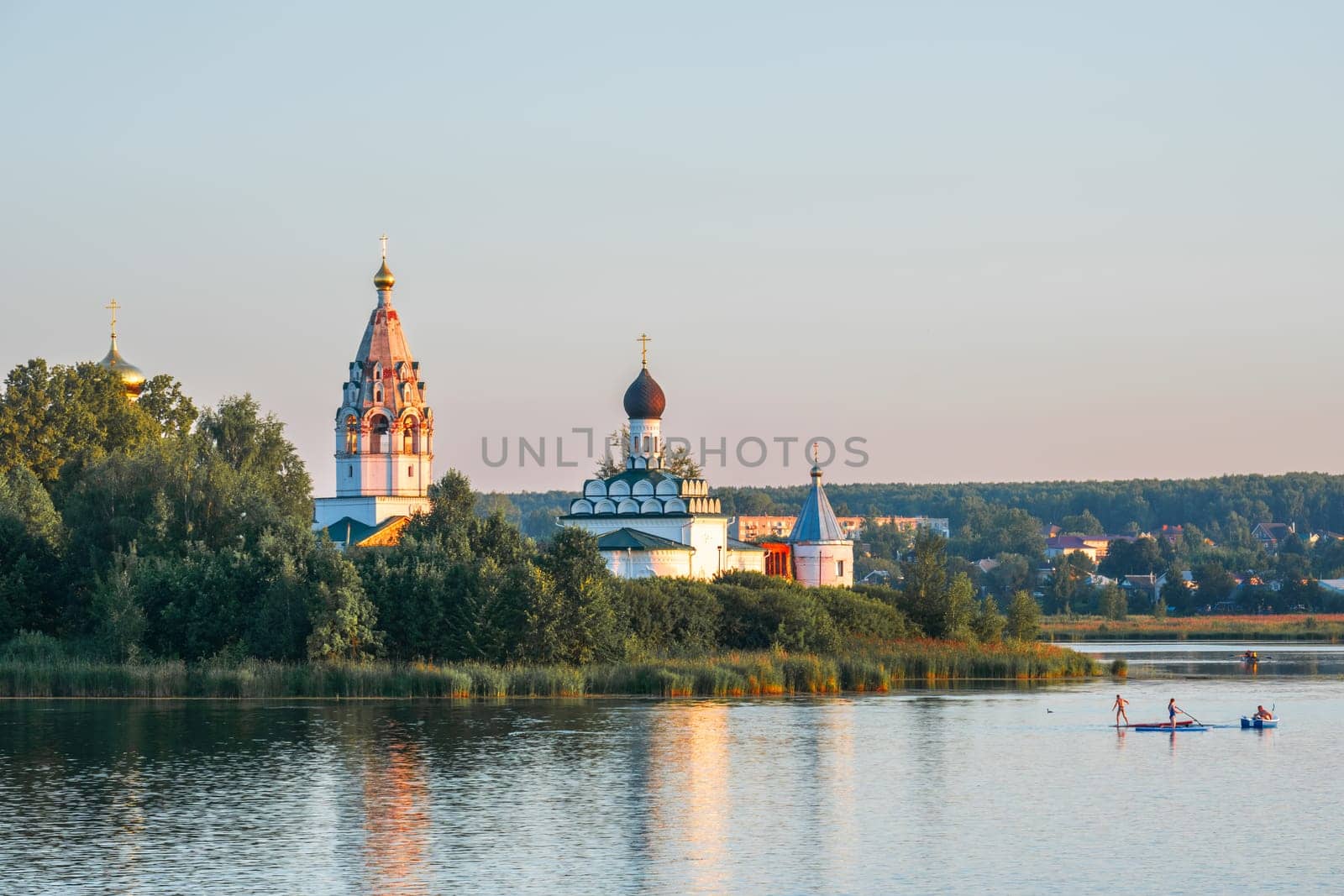 Vorsma, Nizhny Novgorod Region, Russia - 06.08.23. View of the Holy Trinity Ostrovoezersky Monastery with people on boats and SUPs.