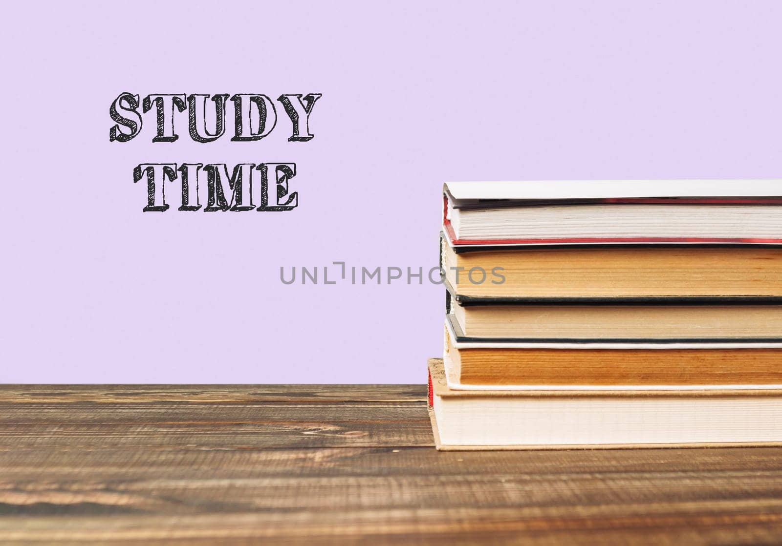 Stack of books with the word study time written on top. The books are piled on top of each other
