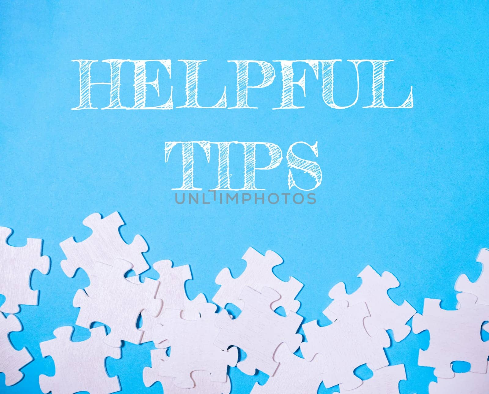 Blue background with white puzzle pieces and the words helpful tips written in white