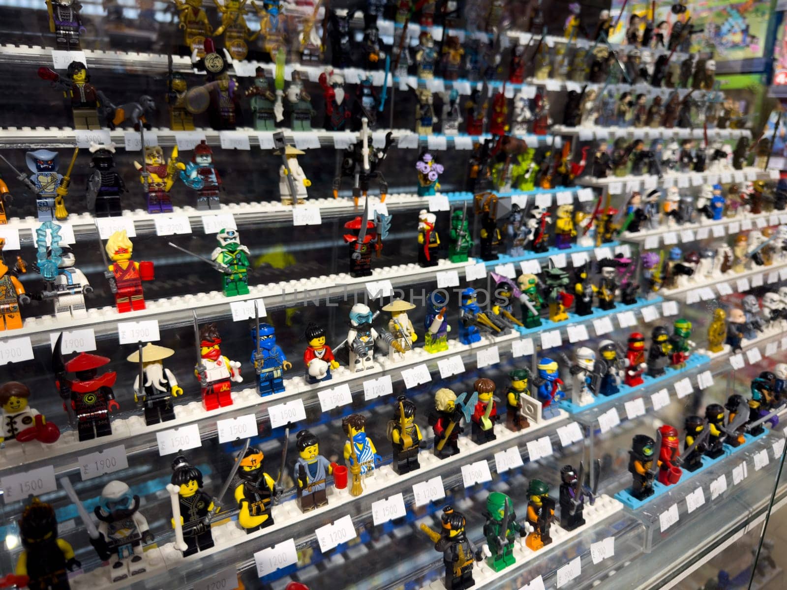 Moscow, Russia, April 25, 2025: Rows of collectible Lego mini figures displayed in Lego themed museum shop where visitors can admire and purchase rare characters from different series and eras