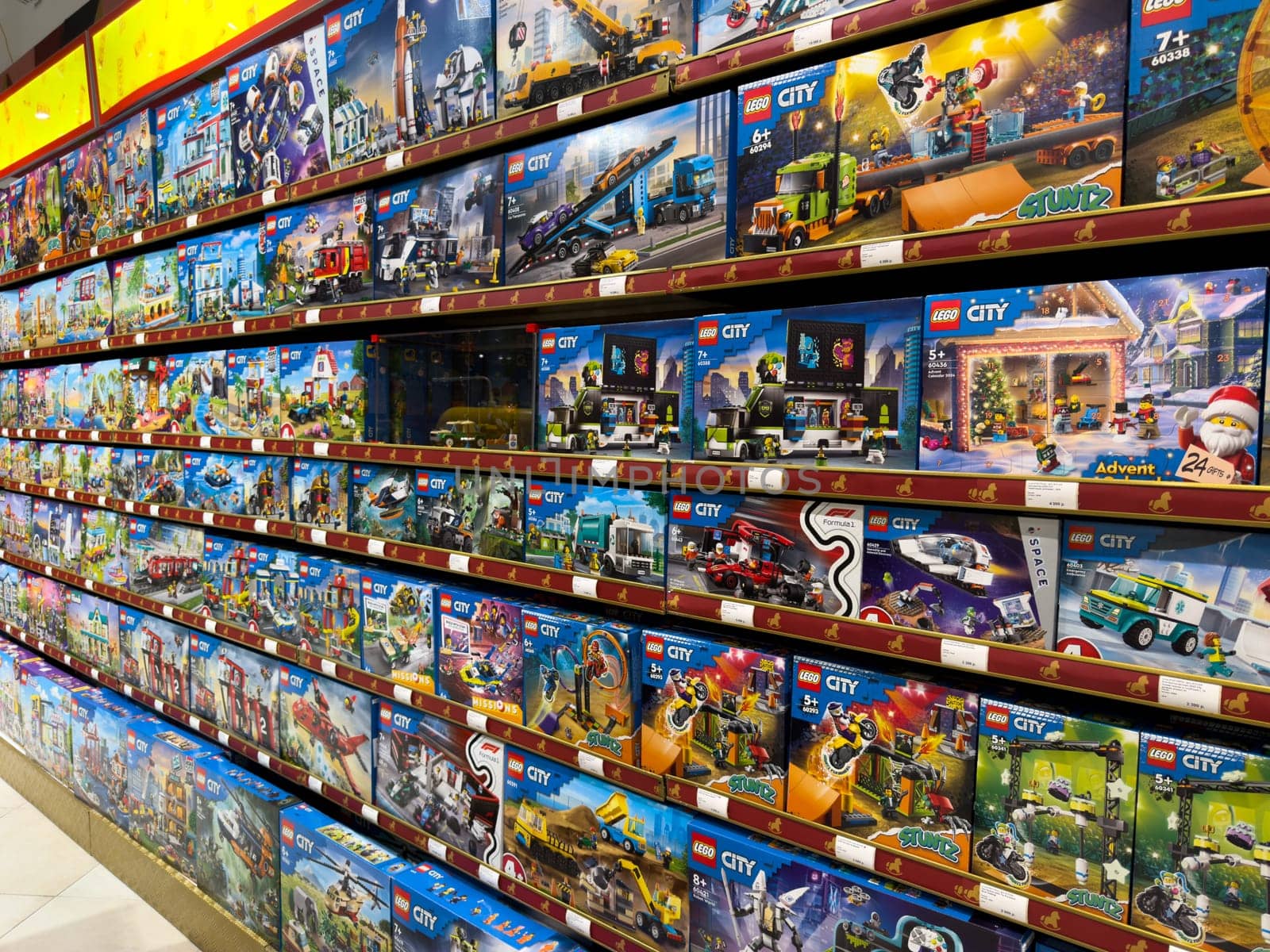 Moscow, Russia, April 25, 2025: Colorful shelves filled with LEGO City construction sets, fire trucks, police stations, space missions and more inside large toy store