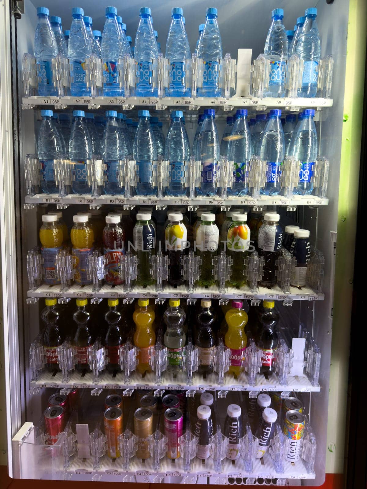 Moscow, Russia, April 25, 2025: Vending machine filled with diverse selection of bottled drinks including mineral water, soda, juice and tea, clearly displaying pricing and product organization