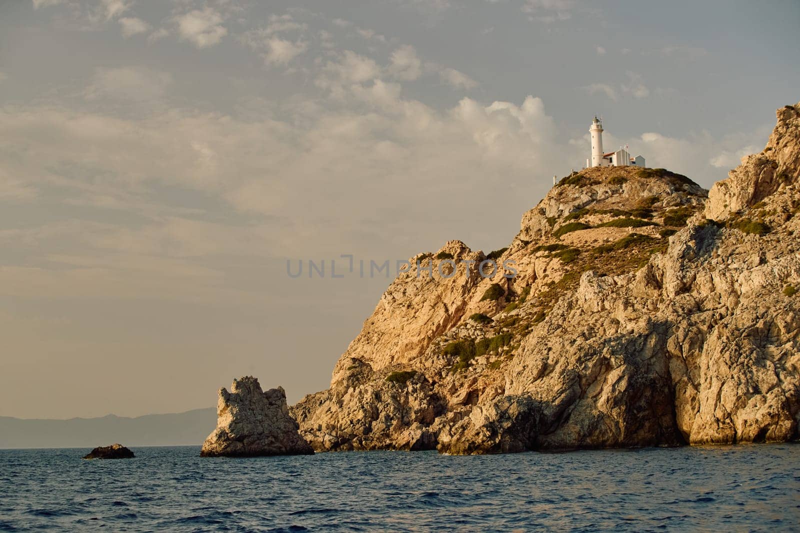 lighthouse on a high mountain at sunset. High quality photo