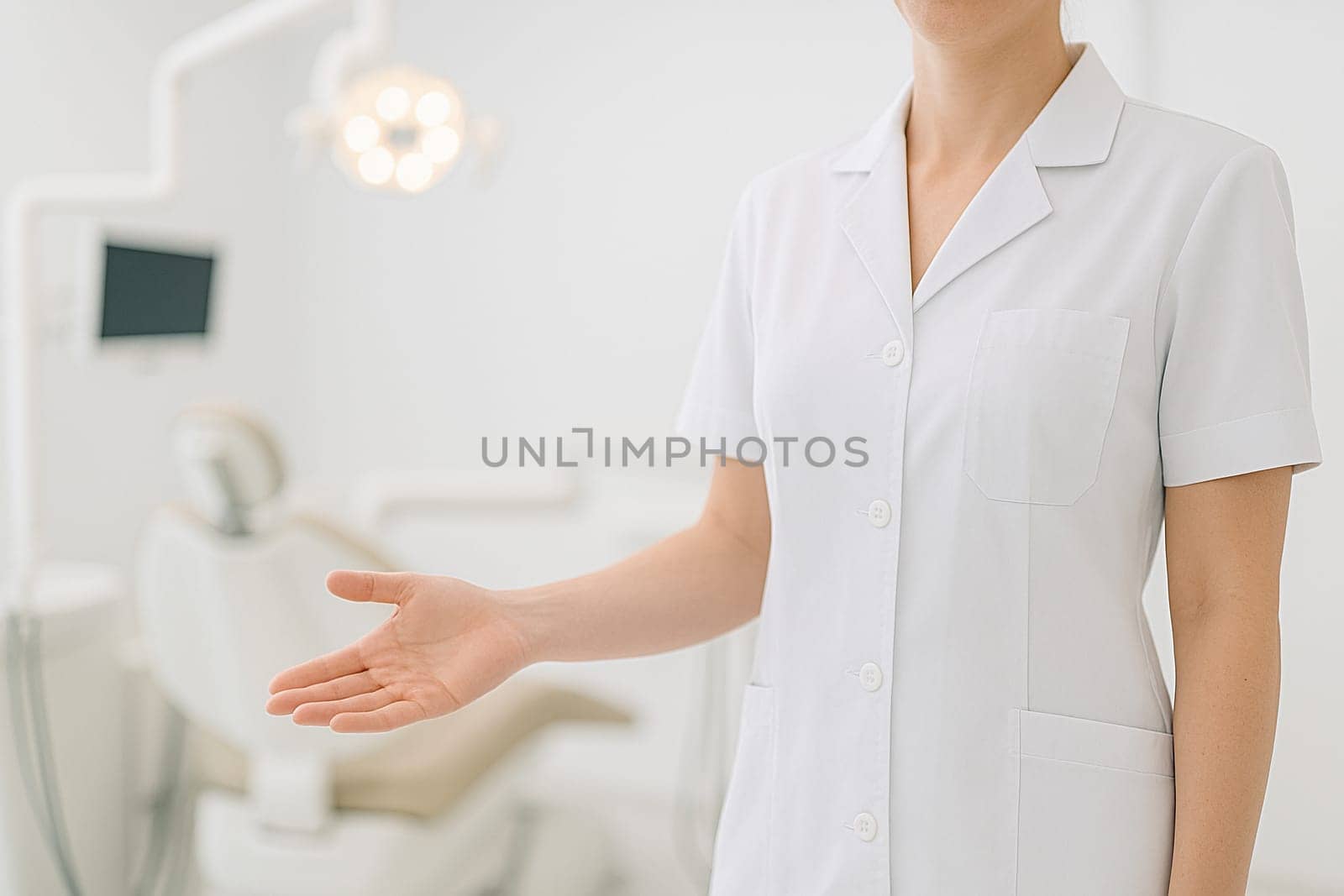 AI generated image of a dentist in white coat standing at the edge of the frame gesturing to welcome a patient into a modern dental clinic treatment room.