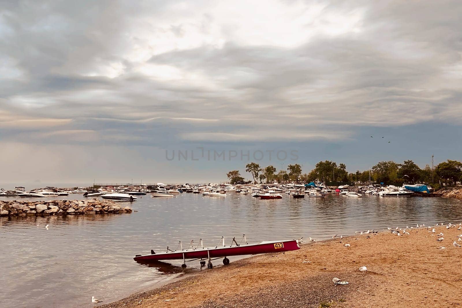 Sunrise and dramatic clouds. Early morning serene seascape in spring. Serene Spring Dawn.Witness the tranquil beauty of an early spring morning. The sun rises, casting a warm glow upon a calm sea, while dramatic clouds paint the sky, creating a breathtaking and serene seascape.