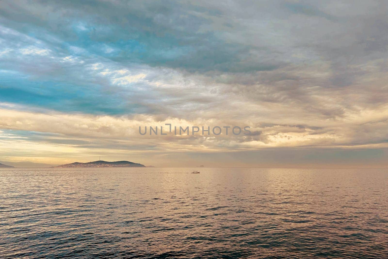 Sunrise and dramatic clouds. Early morning serene seascape in spring. Serene Spring Dawn.Witness the tranquil beauty of an early spring morning. The sun rises, casting a warm glow upon a calm sea, while dramatic clouds paint the sky, creating a breathtaking and serene seascape.