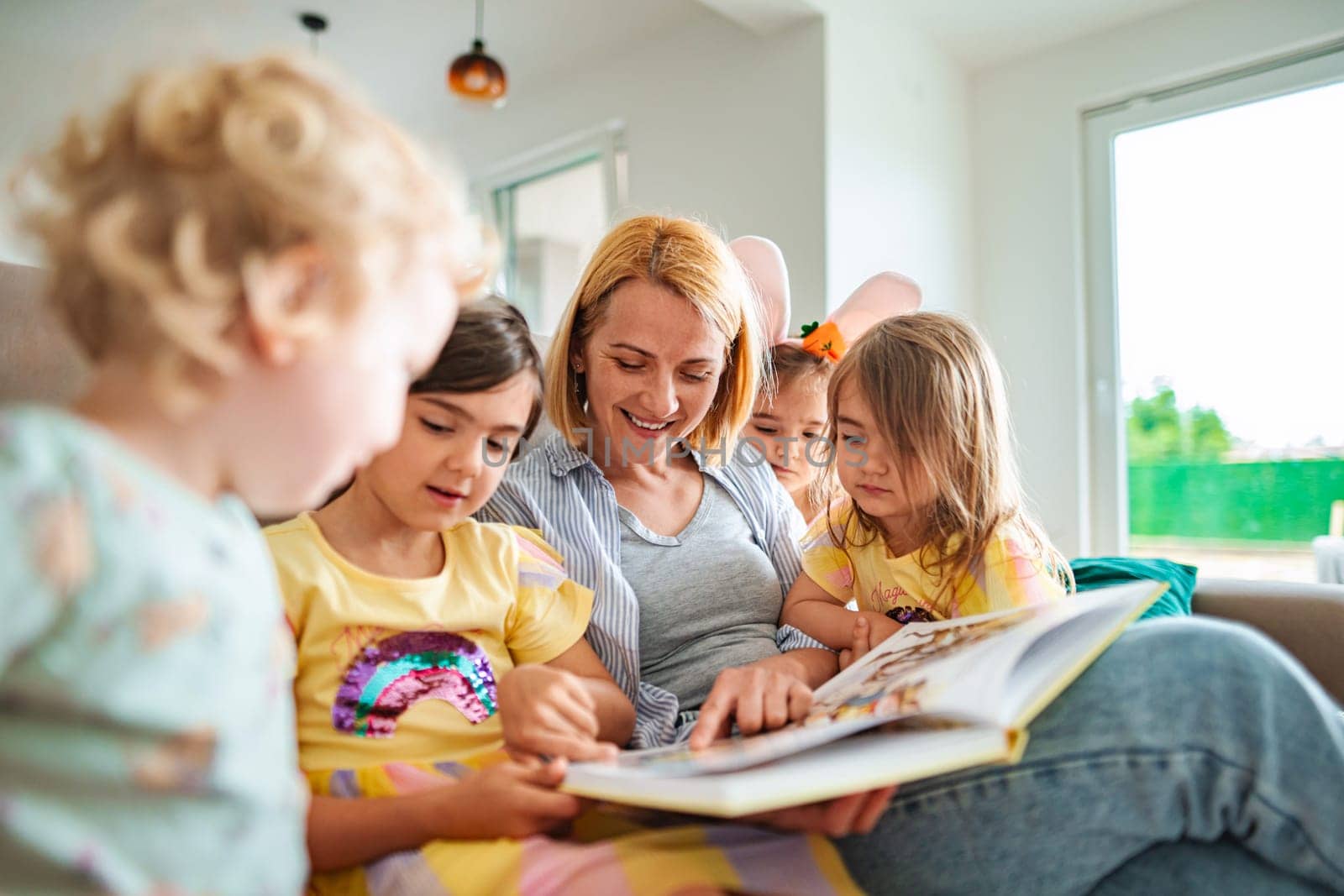 A joyful gathering of children sharing a story with an adult.