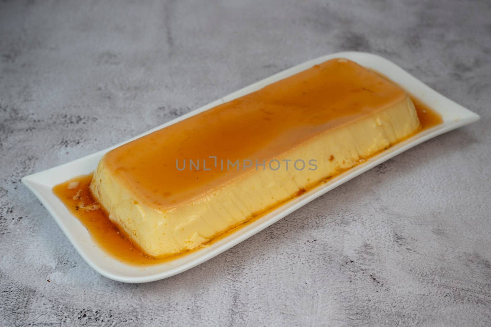 Cream caramel pudding with caramel sauce on a plate, Flan, High quality photo