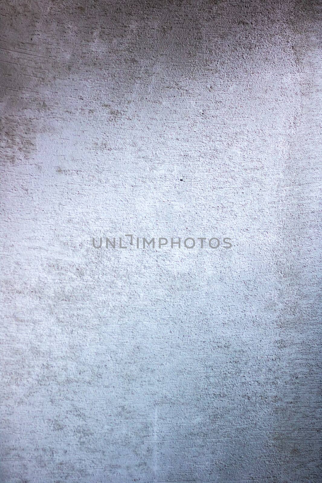 A detailed close up of a gray wall that is adorned with a multitude of small, subtle dots scattered across its surface