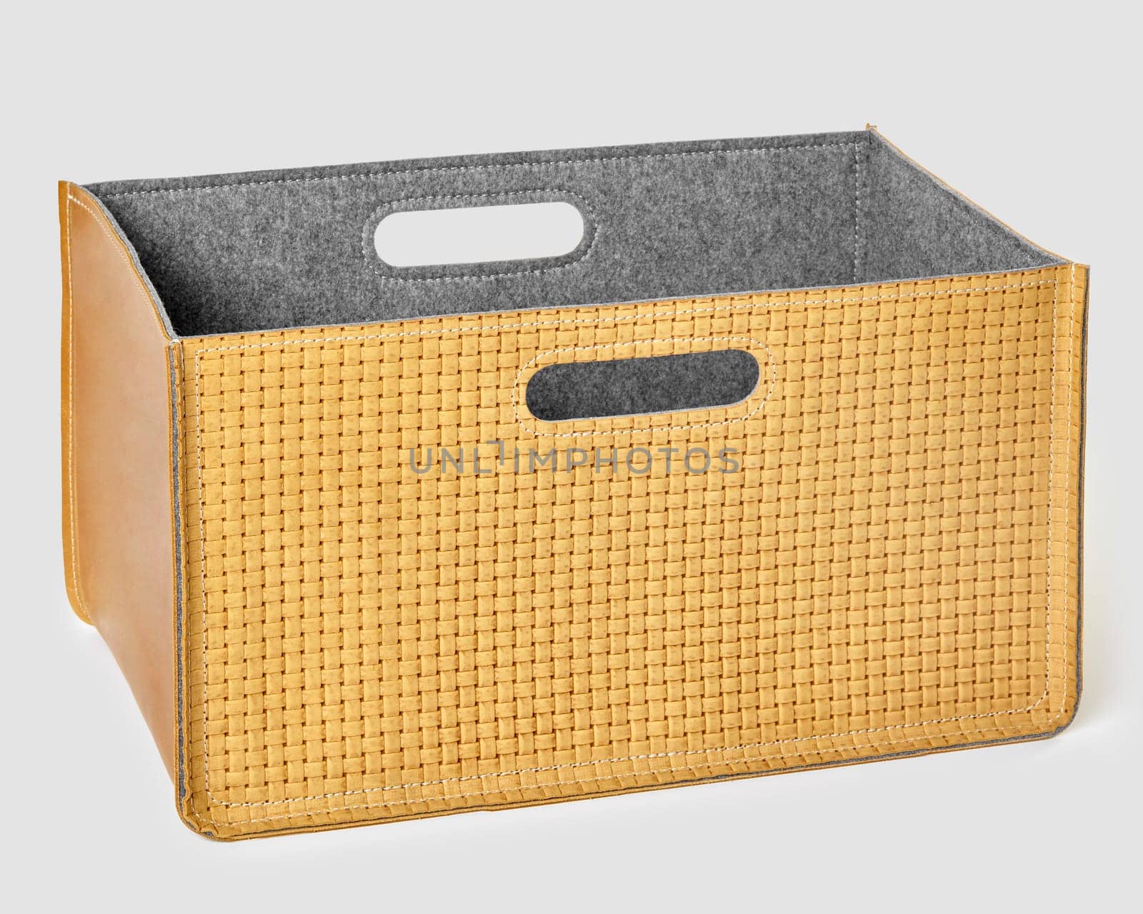 Stylish empty woven leather storage basket with felt lining and convenient handles, perfect for organizing any space