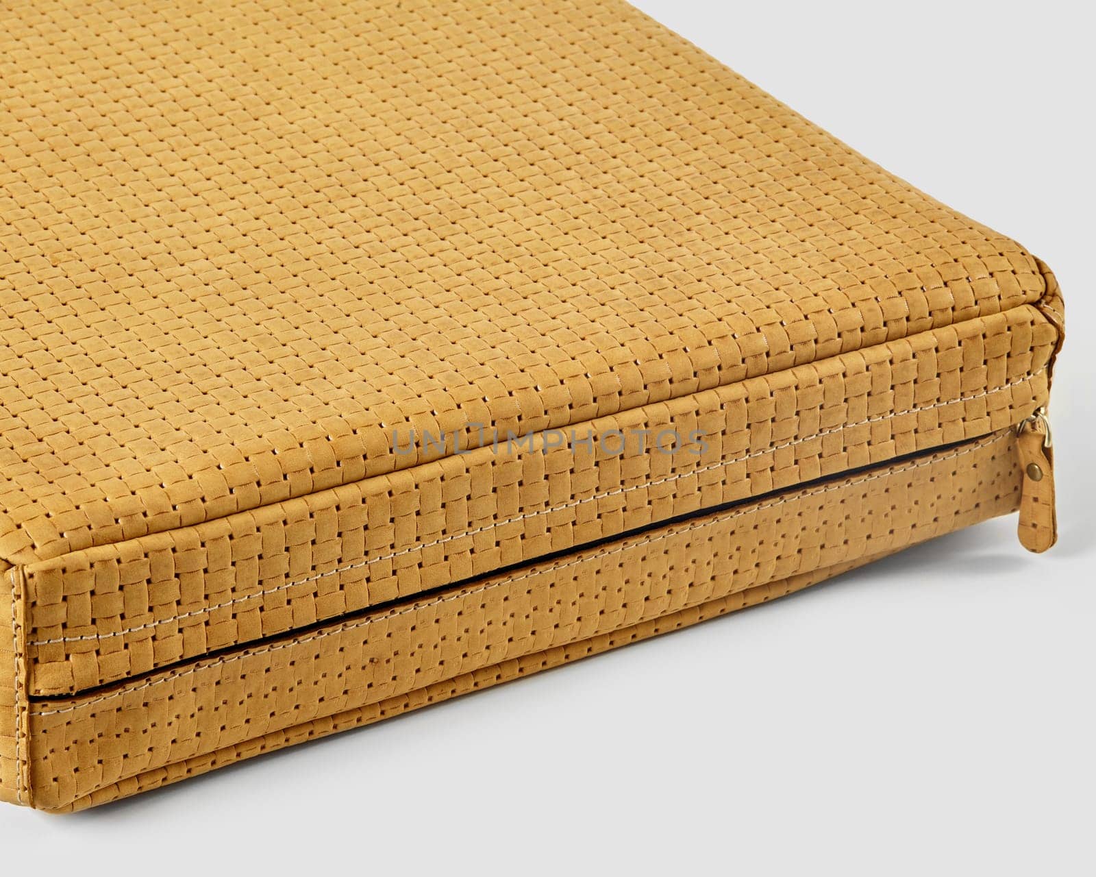 Mustard yellow woven leather bag showcasing its unique texture and meticulous craftsmanship