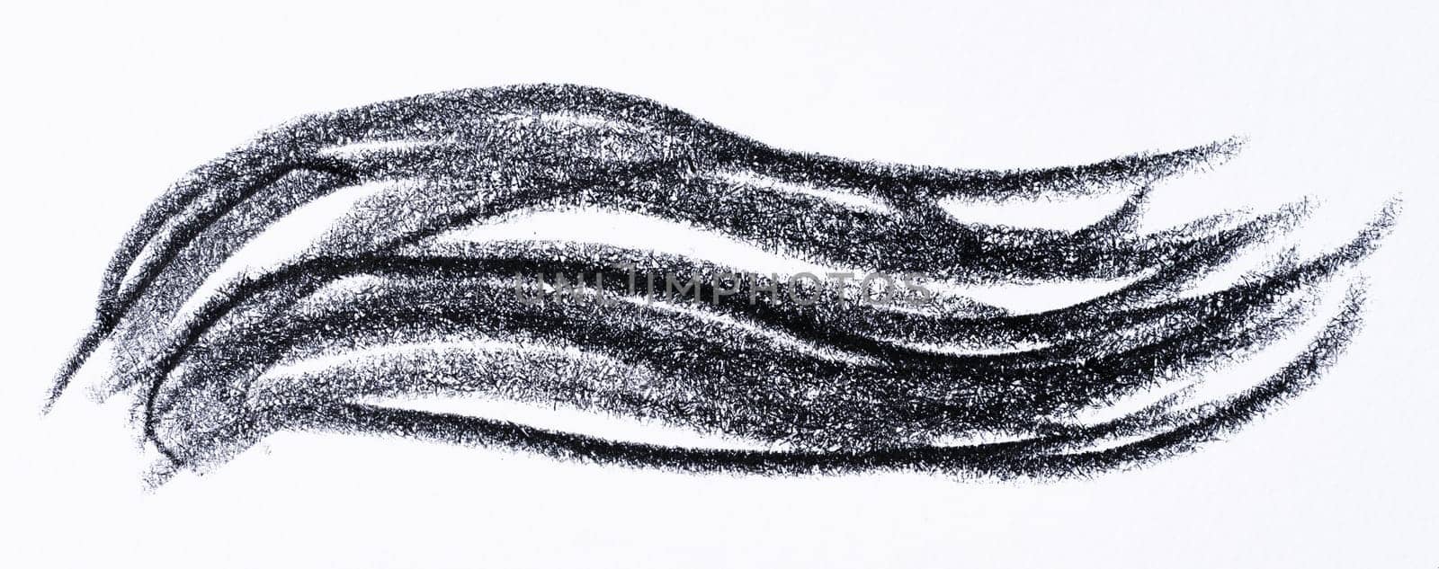Close up of a wavy black pencil or charcoal stroke on an isolated background.