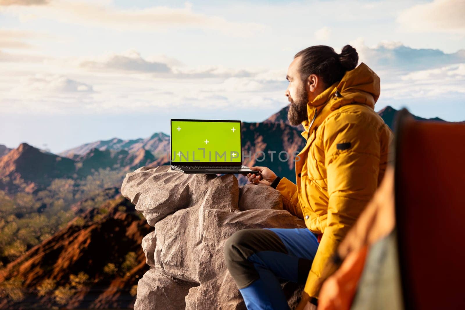 Active hiker gazes at the panoramic sky and copy space display, feeling the sense of peace that comes with exploring the great outdoors. Breathtaking landscape symbolizes resilience.