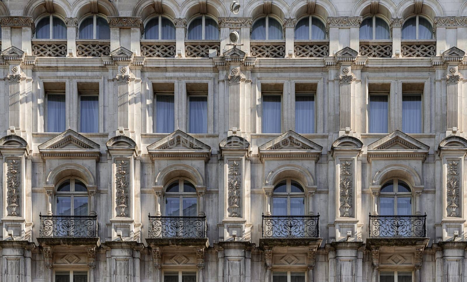 London, UK - May 13, 2025 - A stunning European style of Wrought iron black railings balconies and Classic glass windows in residential tenement building with London victorian architecture. use it as your Wallpaper, Poster and Space for text, Selective focus.