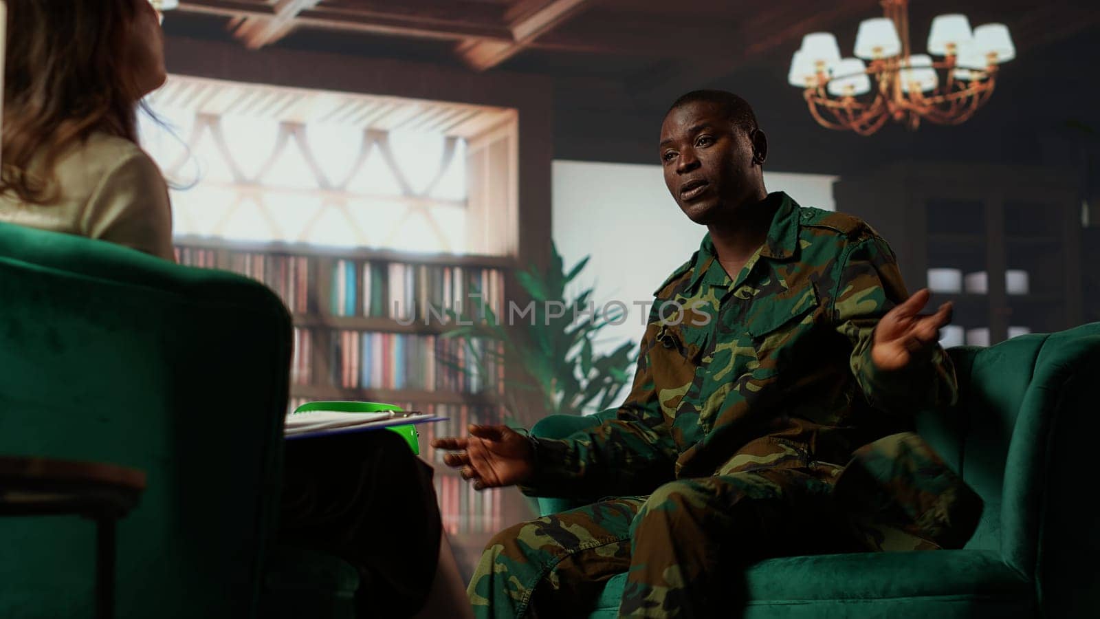 Anxious depressed private sharing his struggles with combat flashbacks, counseling session with psychiatrist for rehabilitation. Psychological support and reintegration for soldiers. Camera B.