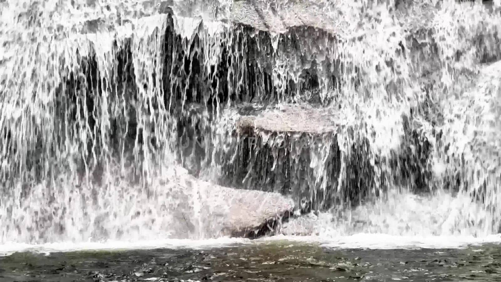 A breathtaking view of a majestic waterfall cascading over rugged rocks a serene natural scene awaits you