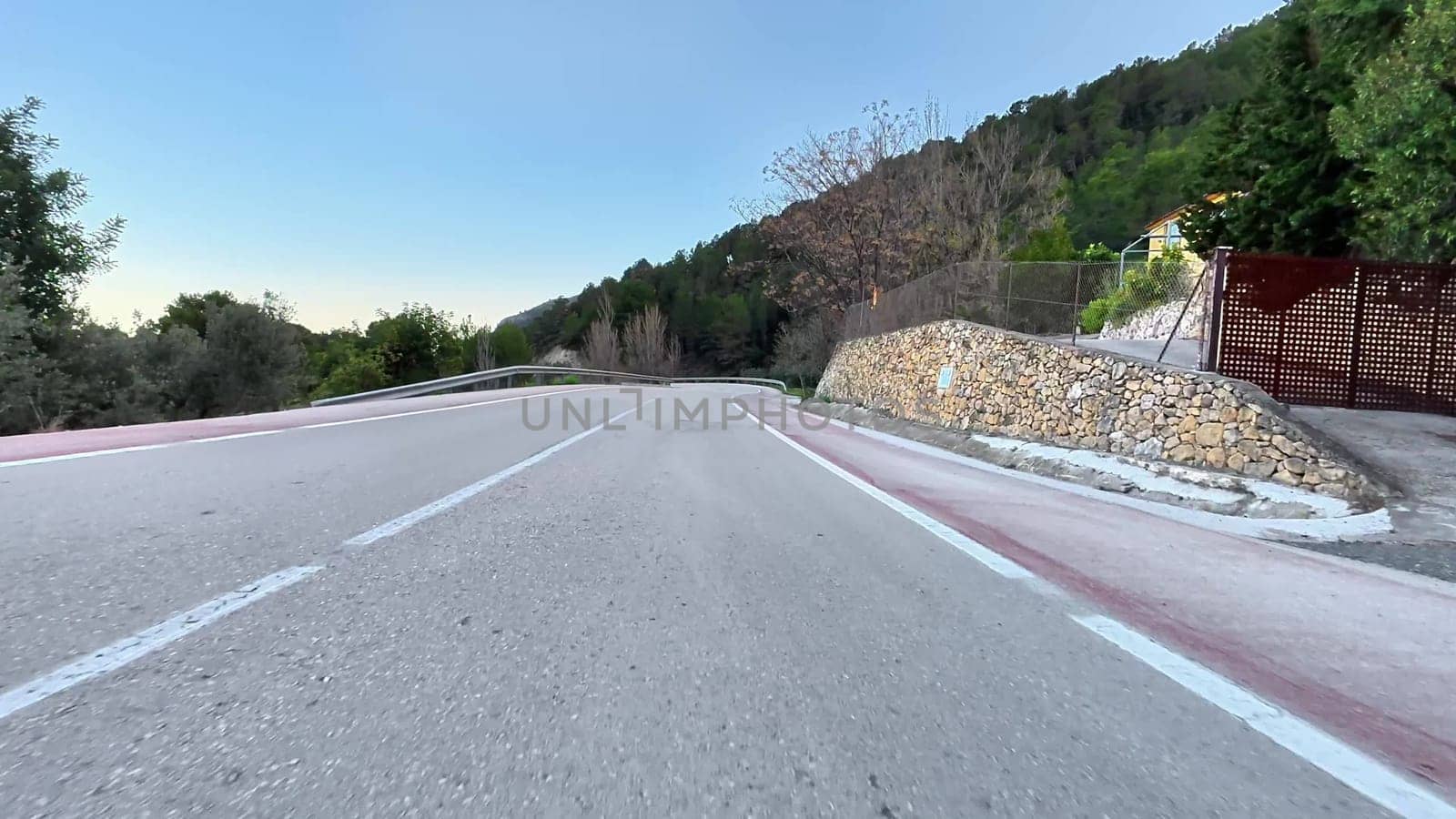 A picturesque winding road surrounded by dense trees and nature's beauty, perfect for scenic drives.