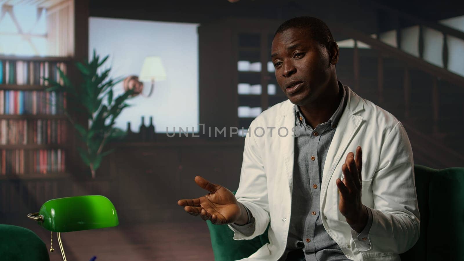 Doctor in white coat opening up about his medical career struggles, suffering from anxiety and mental health issues. Therapist listens with empathy, discussing grief and emotional support. Camera A.