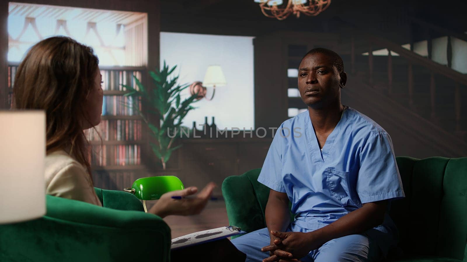 African american nurse struggles with depersonalization condition due to work PTSD, dealing with derealization and being in a dissociative state. Assistant at the hospital has anxiety. Camera A.