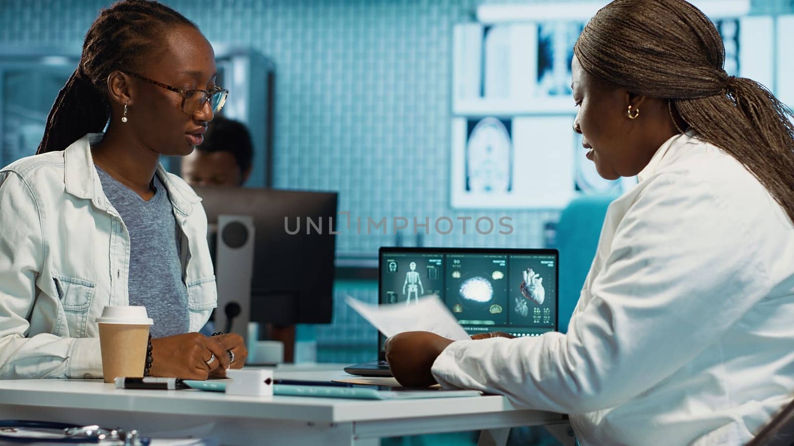 Doctor providing expert advice on health care wellness consulting a patient in a modern facility, evaluating radiology reports and advanced diagnostic tools. Medical therapy. Camera A.