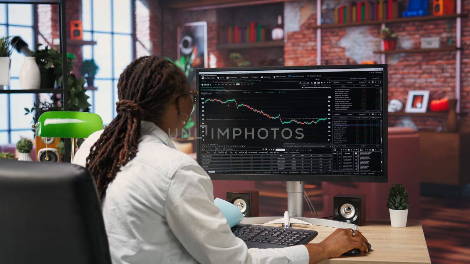 Excited day trader gaining money by selling stocks after browsing through documents to learn how to maximize profits. Thrilled investor celebrating financial gains earned from stock exchange, camera B
