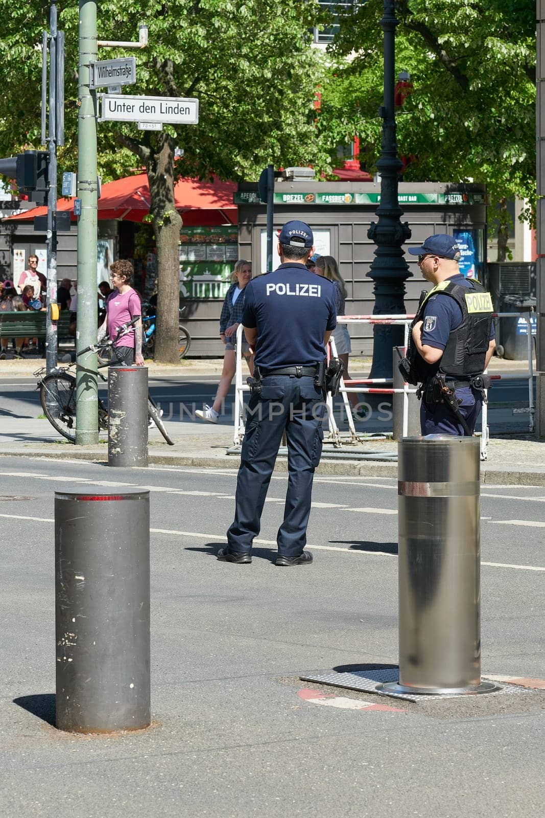 Berlin, Germany – May 01, 2025: Police presence on a street closed with bollards in the center of Berlin