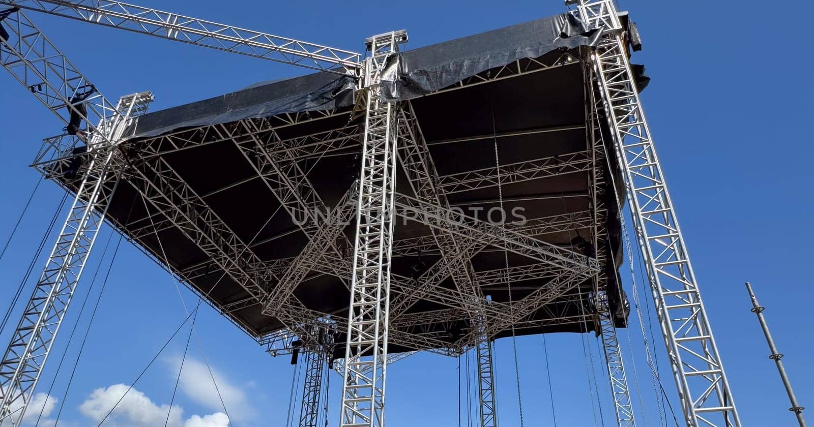 Budva, Montenegro - May 18, 2025: Stage structure being built for Montenegro Independence Day festivities with blue sky backdrop