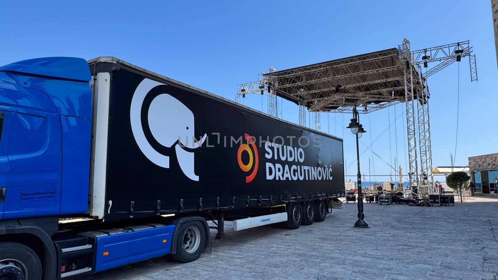Budva, Montenegro - May 18, 2025: Studio Dragutinovic truck is parked near the stage being set up for Montenegro's Independence Day.