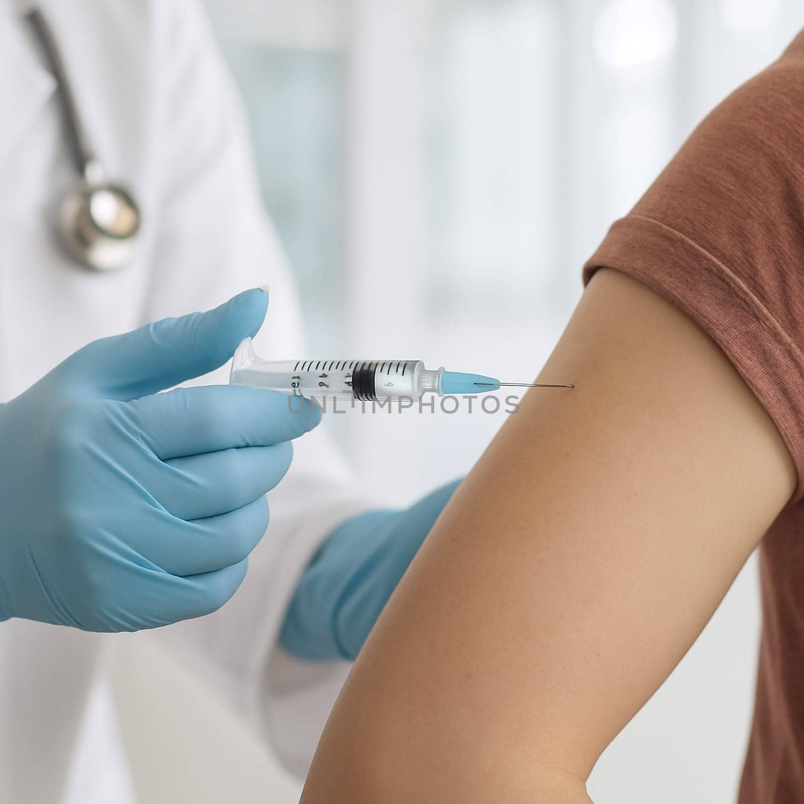 AI generated a close-up of a doctor's hand in medical gloves administering a vaccine injection into a patient's arm in a hospital setting. Focus on healthcare, vaccination, and medical procedure.