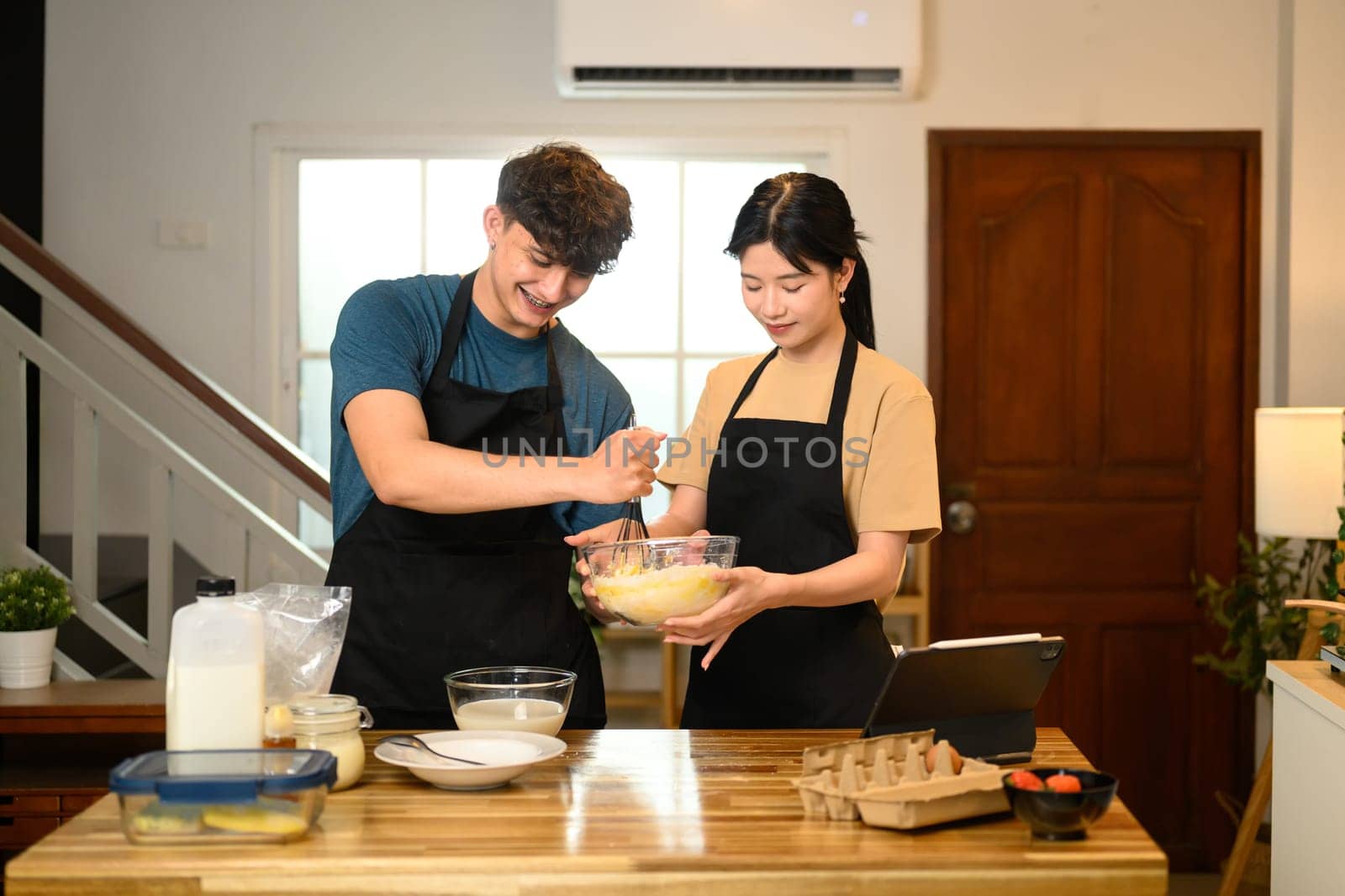 Romantic couple couple prepares breakfast in warm kitchen.