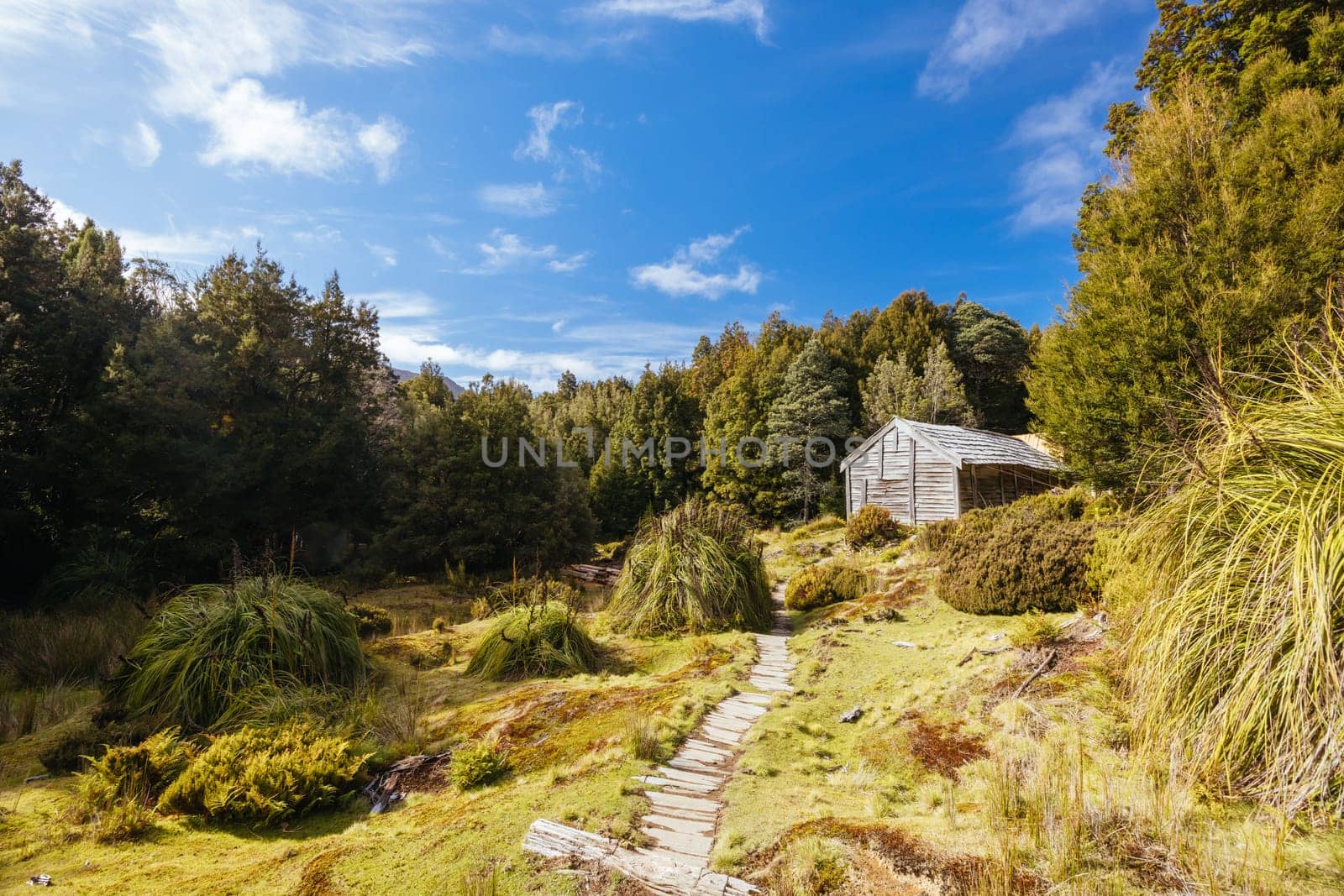 Iconic Du Cane Hut built by Patrick Joseph ‘Paddy’ Hartnett on the Overland Track is the oldest structure in the area. Photographed on a warm autumn morning in Cradle Mountain, Tasmania, Australia