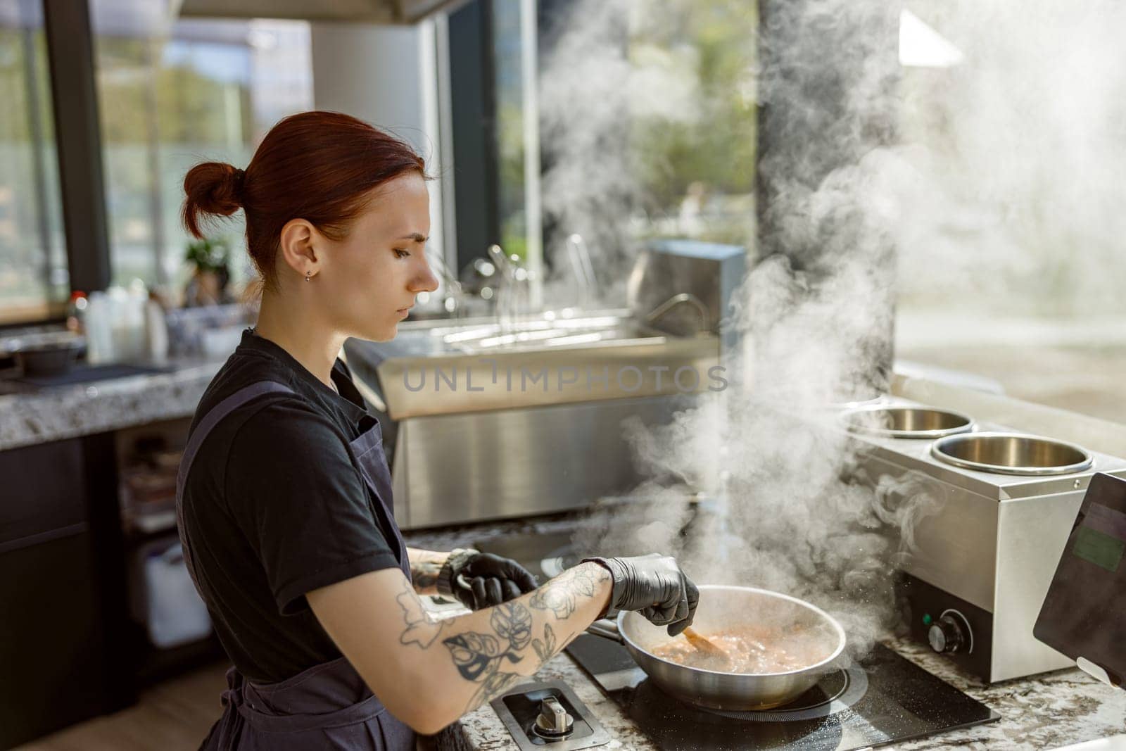 A skilled chef expertly prepares a delicious meal in a modern kitchen that is filled with billowing steam