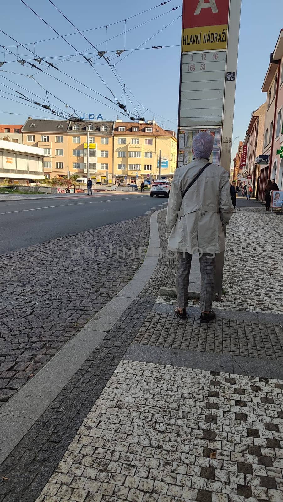 October 22 2024 Hradec Kralove, Czech Republic Europe, Kralov region, Kralovehradecky kraj, Person waiting street building architecture street . High quality photo people city town transport editorial building